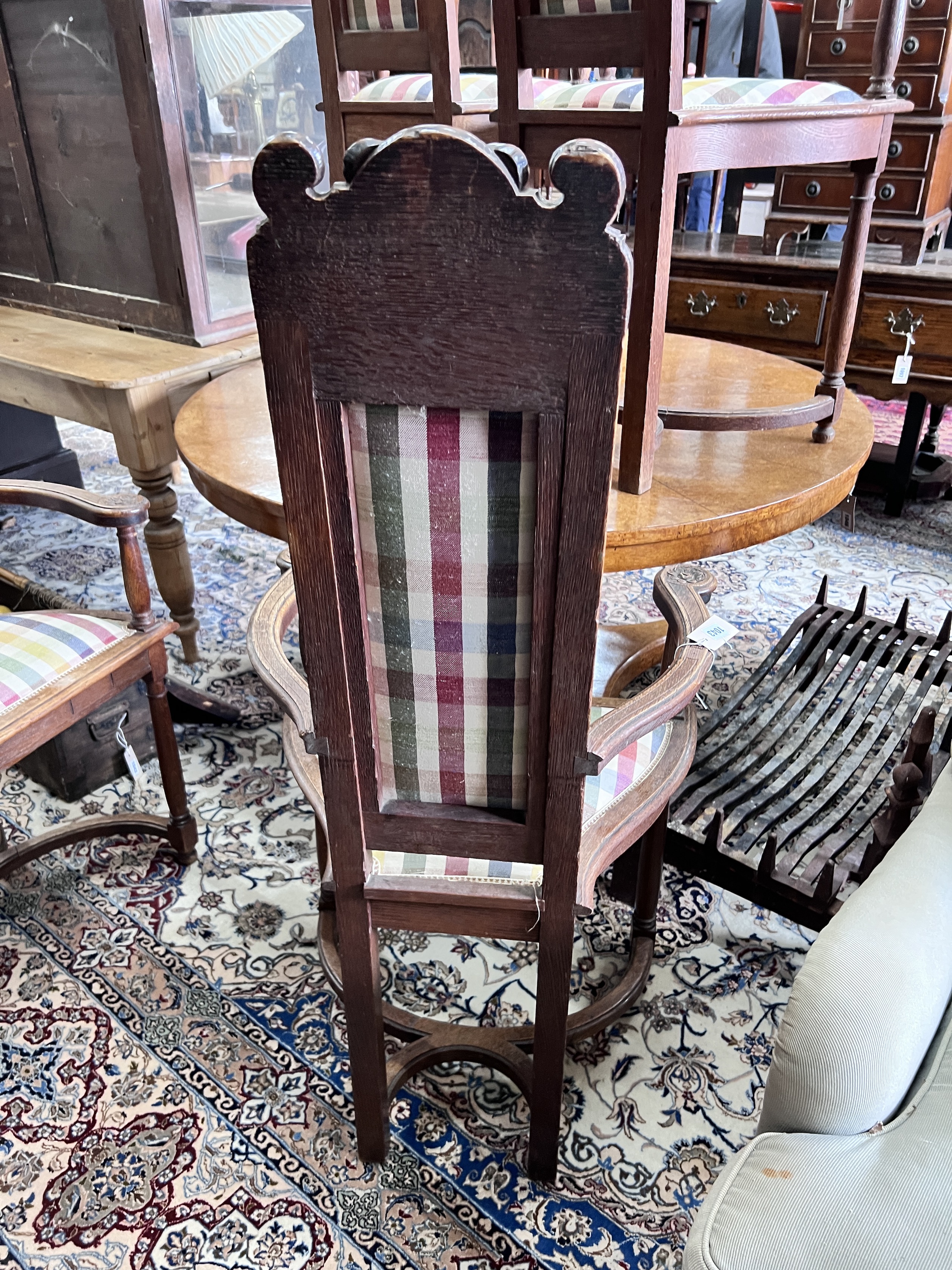 A set of four early 20th century French carved oak elbow chairs, width 59cm, depth 43cm, height 124cm